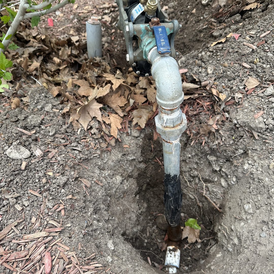 New backflow preventer and mainline valve installed in a service pit